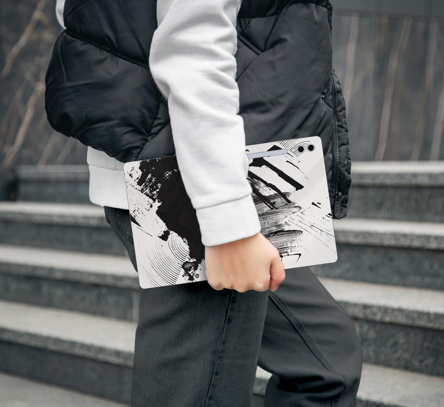 Person holding a Tablet with a black and white design
