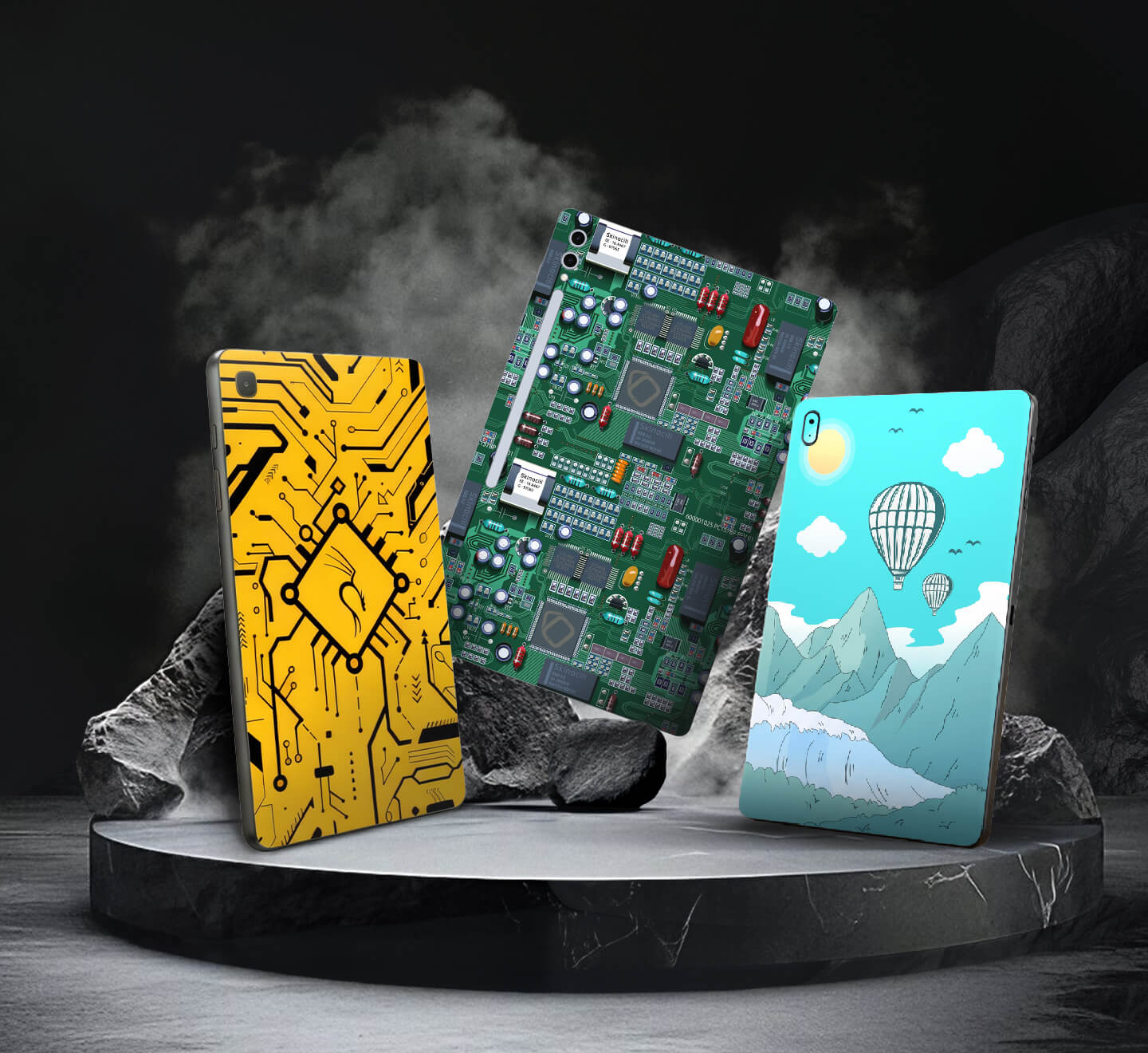 Three tablet skins with different designs on a dark background